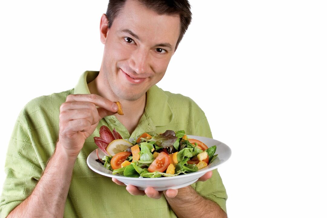 man eats vegetable salad for power